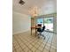 Bright dining area with tile flooring, table, chairs, and sliding glass doors to the outdoor patio at 3325 Honeymoon Ln, Holiday, FL 34691