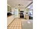 Bright kitchen featuring white cabinets, light countertops, tile floors, and modern appliances at 3325 Honeymoon Ln, Holiday, FL 34691