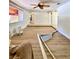 Spacious, light-filled living room with a ceiling fan and views to other rooms at 3325 Honeymoon Ln, Holiday, FL 34691