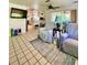 Open concept living room with tile floors, a ceiling fan, and sliding glass doors to the outdoor area at 3325 Honeymoon Ln, Holiday, FL 34691