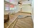 Open living room featuring tile flooring, ceiling fan and natural light at 3325 Honeymoon Ln, Holiday, FL 34691