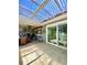 Outdoor patio with a grill, bar, ceiling fan, and tiled flooring at 3325 Honeymoon Ln, Holiday, FL 34691