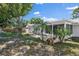 Backyard view with mature trees, patio and some tropical plants at 3370 Harbor Lake Dr, Largo, FL 33770