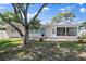 Fenced backyard with mature trees, patio and a grilling area at 3370 Harbor Lake Dr, Largo, FL 33770