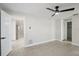 A bright bedroom with neutral paint, tile flooring, closet, and ceiling fan at 3370 Harbor Lake Dr, Largo, FL 33770