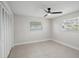 Simple bedroom featuring tile floors, a window with blinds, and a closet with louvered doors at 3370 Harbor Lake Dr, Largo, FL 33770