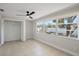 Cozy bedroom featuring tile flooring, closet space, and a large window offering a view of the backyard at 3370 Harbor Lake Dr, Largo, FL 33770