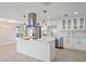 Bright kitchen featuring white cabinetry, stainless steel appliances, quartz countertops, and a kitchen island at 3370 Harbor Lake Dr, Largo, FL 33770