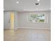Bright living room with tile floors, recessed lighting, and a large window providing ample natural light at 3370 Harbor Lake Dr, Largo, FL 33770