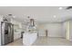 Open concept living room and kitchen area with modern appliances, tile flooring, and recessed lighting at 3370 Harbor Lake Dr, Largo, FL 33770
