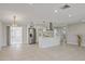 Open concept living room and kitchen area with modern appliances, tile flooring, and recessed lighting at 3370 Harbor Lake Dr, Largo, FL 33770