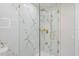 Marble tiled glass shower with gold fixtures at 3370 Harbor Lake Dr, Largo, FL 33770
