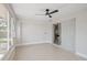 Bright sunroom features tile flooring, sliding glass doors, and a ceiling fan at 3370 Harbor Lake Dr, Largo, FL 33770