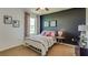 Cozy bedroom with a black accent wall, full sized bed and bright colored textiles at 4312 112Th E St, Palmetto, FL 34221
