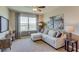 Living room with modern decor, comfortable seating, and a large window offering picturesque views at 4312 112Th E St, Palmetto, FL 34221