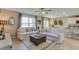 Bright living room with comfortable sofas, modern decor, and open to kitchen and dining area at 4312 112Th E St, Palmetto, FL 34221