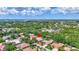 Aerial view of a home surrounded by trees and other houses, showcasing the neighborhood at 4730 Old Farm Rd, Sarasota, FL 34233