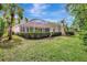 Backyard view with lush landscaping and screened-in pool area, perfect for outdoor enjoyment at 4730 Old Farm Rd, Sarasota, FL 34233