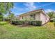 Backyard view with lush landscaping and screened-in pool area, highlighting privacy at 4730 Old Farm Rd, Sarasota, FL 34233