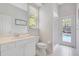 Bright bathroom with tiled floor and walk-in shower and sink at 4730 Old Farm Rd, Sarasota, FL 34233