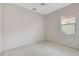 Bright bedroom with neutral carpet and paint, ceiling fan, and a large window that fills the room with natural light at 4730 Old Farm Rd, Sarasota, FL 34233