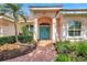 Welcoming front entrance with a brick pathway, colorful door, and lush landscaping at 4730 Old Farm Rd, Sarasota, FL 34233