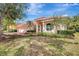 Inviting home with lush landscaping, a coral-toned exterior, tile roof, and a brick driveway at 4730 Old Farm Rd, Sarasota, FL 34233