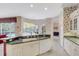 Open kitchen with bright wallpaper, tiled flooring, with views of the pool, and plenty of natural light, perfect for gatherings at 4730 Old Farm Rd, Sarasota, FL 34233