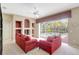 Comfortable living room with red couches, built-in shelving, and access to the pool area at 4730 Old Farm Rd, Sarasota, FL 34233
