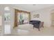 Bright living room featuring neutral tile floors, patio access, and comfortable seating, perfect for relaxing and entertaining at 4730 Old Farm Rd, Sarasota, FL 34233
