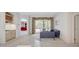 Inviting living room with neutral tile floors and sliders to the screened in pool, perfect for enjoying indoor-outdoor living at 4730 Old Farm Rd, Sarasota, FL 34233
