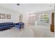 Sunlit living room with a large window and neutral decor, creating a calming ambiance at 4730 Old Farm Rd, Sarasota, FL 34233