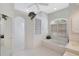 Well-lit main bathroom with a large soaking tub, glass block accents, and neutral decor at 4730 Old Farm Rd, Sarasota, FL 34233