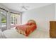 Bright main bedroom with tropical decor and private lanai access overlooking the pool area at 4730 Old Farm Rd, Sarasota, FL 34233