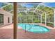 Stunning screened pool and spa with brick paver deck and access steps at 4730 Old Farm Rd, Sarasota, FL 34233