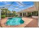 Inviting in-ground screened pool and spa with brick paver deck at 4730 Old Farm Rd, Sarasota, FL 34233