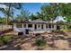 A view of the backyard that includes the exterior of the home and shade at 4918 Lahaina Dr, Sarasota, FL 34232