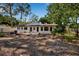 A view of the backyard that includes the exterior of the home and a partial fence at 4918 Lahaina Dr, Sarasota, FL 34232