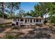 A view of the backyard that includes the exterior of the home and some trees at 4918 Lahaina Dr, Sarasota, FL 34232