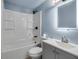 Bathroom with a shower-tub, gray vanity with a sink, toilet, and a lighted mirror at 4918 Lahaina Dr, Sarasota, FL 34232