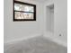 An empty room with an open closet and a window overlooking the yard at 4918 Lahaina Dr, Sarasota, FL 34232