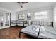 A sun-filled bedroom with hardwood floors and multiple windows at 4918 Lahaina Dr, Sarasota, FL 34232