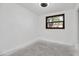 The unfurnished bedroom has a dark-framed window with tree view and a neutral wall at 4918 Lahaina Dr, Sarasota, FL 34232
