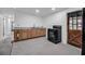 Kitchen featuring light wood cabinets, modern oven, and a rustic door with dark wood at 4918 Lahaina Dr, Sarasota, FL 34232