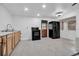 Kitchen with light-colored cabinets, black oven, and refrigerator; a rustic door and window are also visible at 4918 Lahaina Dr, Sarasota, FL 34232