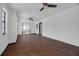 Open living room with hardwood floors, ceiling fan, and natural light coming through the windows at 4918 Lahaina Dr, Sarasota, FL 34232