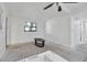 Living room featuring a window with tree views; neutral walls and ceiling fan are also visible at 4918 Lahaina Dr, Sarasota, FL 34232