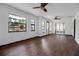 Bright living room featuring hardwood floors, a ceiling fan and multiple windows bringing in natural light at 4918 Lahaina Dr, Sarasota, FL 34232