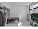 A view of a room that includes an unpainted floor with a water heater and a window at 4918 Lahaina Dr, Sarasota, FL 34232