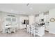 Bright kitchen with white cabinets, granite countertops, stainless steel appliances, and a casual dining area at 5514 Spanish Moss Cv, Bradenton, FL 34203